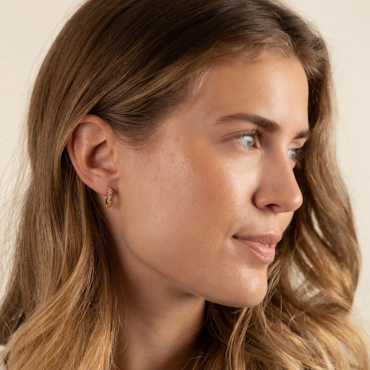 CLAIR CRYSTAL GOLDEN SMALL HUGGIE EARRING - Image 4