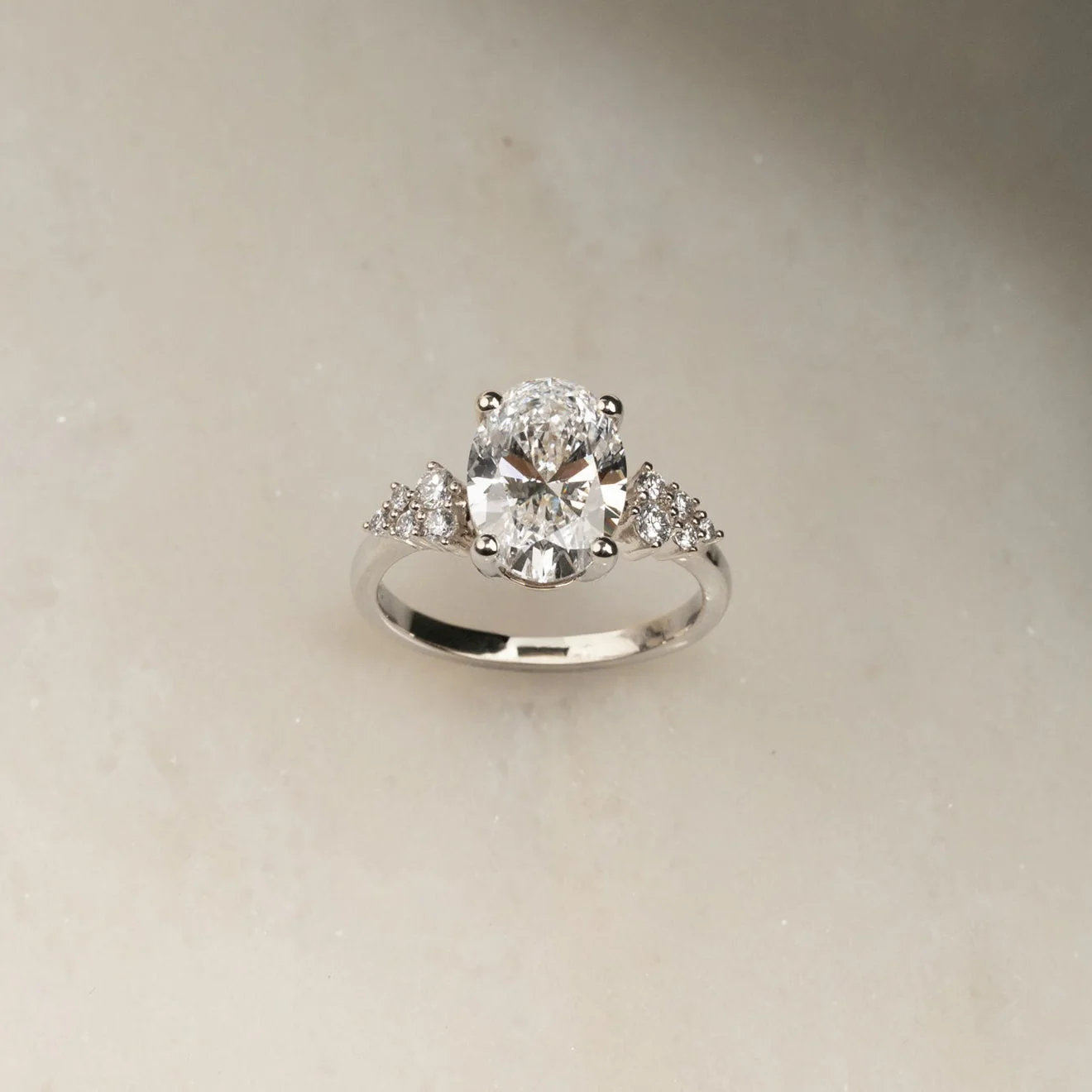 DELICATE CLUSTER OVAL-CUT DIAMOND RING